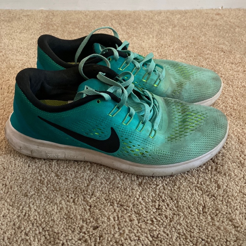 Teal and lime green ombré Nike free runs.